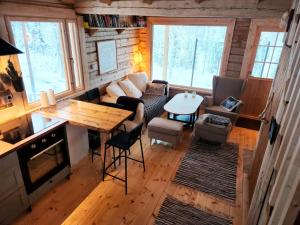 an aerial view of a living room and kitchen in a tiny house at Lapland Riverside Cabin, Äkäsjoki Hideaway - Riverview, Traditional Sauna, Avanto, WiFi, Ski, Ylläs in Äkäsjoensuu