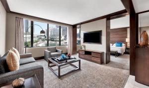 a living room with a couch and a tv at Mandarin Oriental, Jakarta in Jakarta