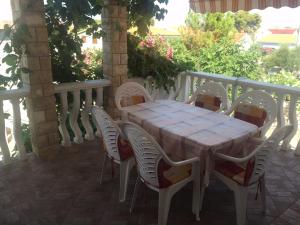 a white table and chairs on a patio at Apartment Krmpotić in Vir