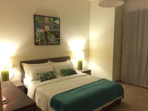 a bedroom with a large bed with two lights on at Holiday Dreams in Francavilla al Mare