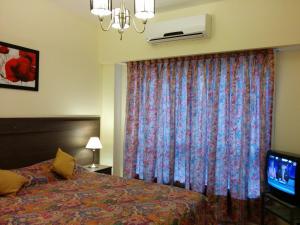 Ένα ή περισσότερα κρεβάτια σε δωμάτιο στο Apartamento Edificio Crucero