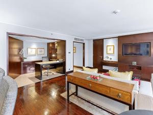 a living room with a couch and a table at Mandarin Oriental, Jakarta in Jakarta
