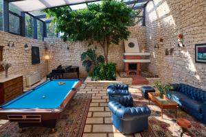 a living room with a pool table in it at Villa Diocletian's Palace in Supetar
