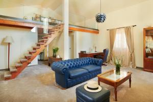 a living room with a blue couch and a staircase at Villa Diocletian's Palace in Supetar