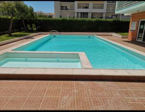 a swimming pool in the middle of a building at Espírito Santo Apartament in Portimão
