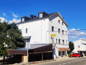 a white building with a sign that reads hotel at Hostal Martin - Sanabria in Ribadelago