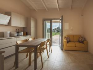 a kitchen and dining room with a table and chairs at Villa Aris in Villa Gorizia