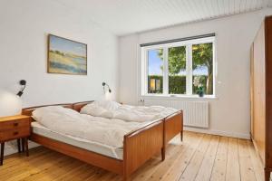 a bedroom with a bed and a window at Renovated Home In Rural Idyll, Close To The Beach in Haderslev