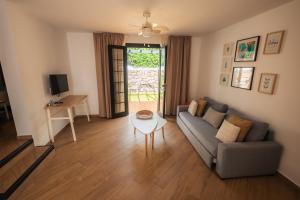 a living room with a couch and a table at Los Cardones Boutique Village in Playa de las Americas