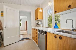 a kitchen with a sink and a dishwasher at Renovated Home In Rural Idyll, Close To The Beach in Haderslev