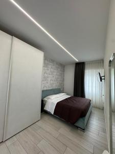 a bedroom with a bed and a sliding door at Residence Cervia in Cervia