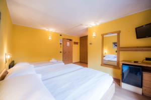 Posteľ alebo postele v izbe v ubytovaní Hotel Angelica