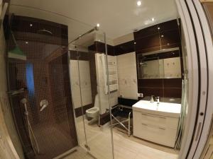 a bathroom with a glass shower and a sink at Apartament Blue Mare Łukęcin Spacerowa 6 in Łukęcin +10 photos