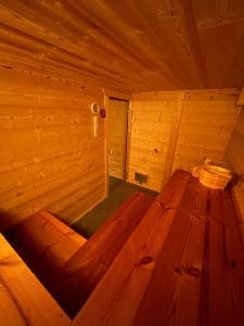 a wooden sauna with a wooden bench in a room at Chalet Isard Pyrénées 2000 - 300m des pistes in Bolquere Pyrenees 2000