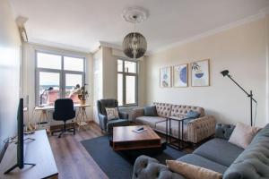 a living room with a couch and a table at Soft and Historic 3BR Home w Iconic Haydarpasa View in Istanbul
