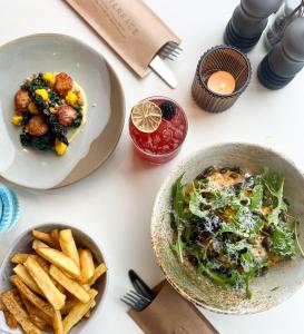 a white table with plates of food and french fries at Housel Bay Hotel in Lizard