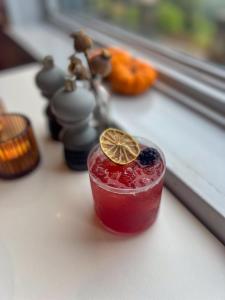a drink with a lemon slice on top of it at Housel Bay Hotel in Lizard