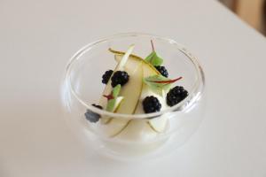 a small glass dish with fruit on a white table at Housel Bay Hotel in Lizard