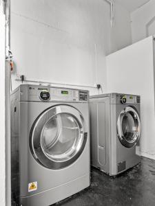 two washing machines sitting next to each other in a room at Potts Point Budget Stay - Near Kings Cross Station - Self Check-in in Sydney