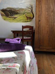 a bedroom with a bed and a painting of a deer at Nido D'Ape bed and breakfast in  Montepetra  +71 photos