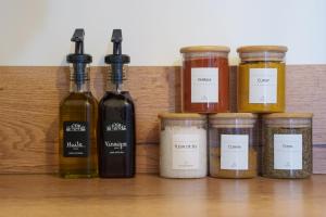 a group of four bottles of oils and jars at La Cour du Cygne - By PrestiPlace in Tours +20 photos