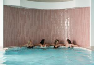 a group of four women in a swimming pool at St Moritz Hotel and Cowshed Spa in Polzeath