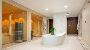 a lobby with a potted plant in the middle of a building at St Moritz Hotel and Cowshed Spa in Polzeath