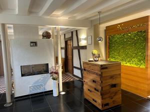 a living room with a fireplace and a table at Kragemann Hotel & Vinothek in Simmerath