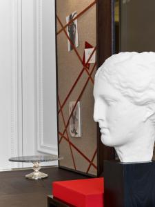 a white head statue on a table with a red box at Baccarat Hotel and Residences New York in New York