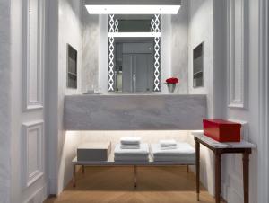 a room with a mirror and a table with towels at Baccarat Hotel and Residences New York in New York