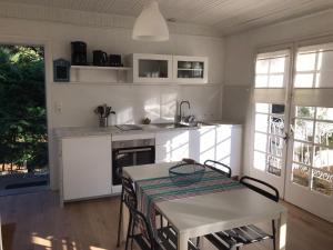 a kitchen with a table and a table and chairs at La Gimoniere in La Barre-de-Monts