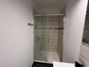 a shower with a glass door in a bathroom at Calais Wilson 2 - Studio Balneo 2p in Calais
