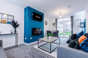 a living room with a couch and a table at NEW! 3-Bed Home in Manchester by 53 Degrees Property, Ideal for Contractors & Business Stays, Sleeps 8! in Manchester +6 photos