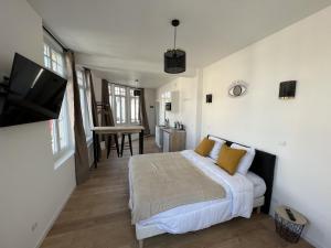 a bedroom with a bed and a flat screen tv at La Suite Balneo 2p - centre ville in Liévin