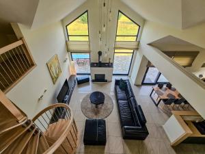 a living room with a couch and a table at Sand Valley Golf Resort in Pasłęk