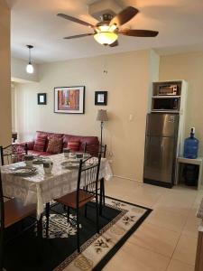 a living room with a table and a couch at Belle's Staycation in Cebu City