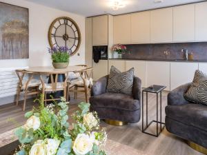a living room with two chairs and a table at Arran Shores Luxury Shorefront Apartment 14 in Lamlash