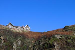 a house on the side of a cliff at Housel Bay Hotel in Lizard