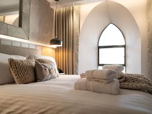 a bedroom with a large bed with a large window at Arran Shores Luxury Shorefront Apartment 3 in Lamlash