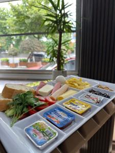 a tray with different types of food on a table at Garden Room Suit Hotel in Istanbul
