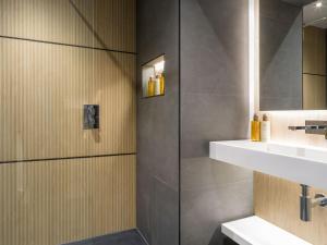 a bathroom with a shower and a sink at Arran Shores Luxury Shorefront Suite 1 in Lamlash +25 photos