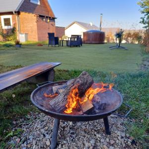 MiechucinoCicha przystań domek na Kaszubach的 ⁇ 火坑,木柴在板凳旁边