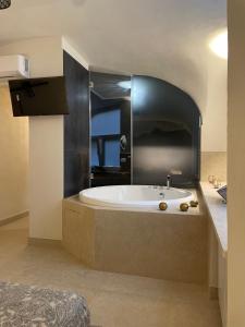un bagno con ampia vasca e lavandino di Domus Parthenope Deluxe a Napoli