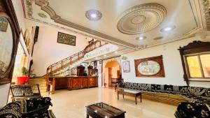 a living room with chairs and a staircase at Hotel Master Paradise, Pushkar, Rajasthan , INDIA in Pushkar