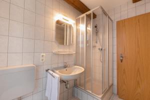 a bathroom with a sink and a shower at Hotel Stadt Lüdenscheid, Domizil Herzogstraße in Lüdenscheid
