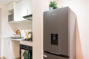 cocina con nevera de acero inoxidable y fogones en Prime location Ritzy Umhlanga Bachelor, en Durban