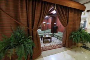 a living room with a couch and a table at Habitat All Suites, Al Khobar in Al Khobar