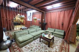 a living room with a couch and a table at Habitat All Suites, Al Khobar in Al Khobar +76 photos