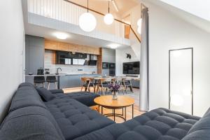 a living room with a blue couch and a table at Residence Krušec in Abertamy