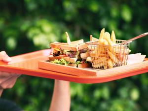 a plate of food with a sandwich and french fries at Ibis Saigon Airport in Ho Chi Minh City
